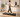 A remote worker walking on an under-desk treadmill at an adjustable standing desk in a bright home office.